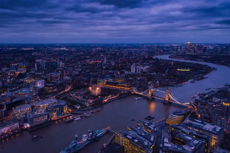 Aerial view of the River Thames and Tower Bridge in London at dusk